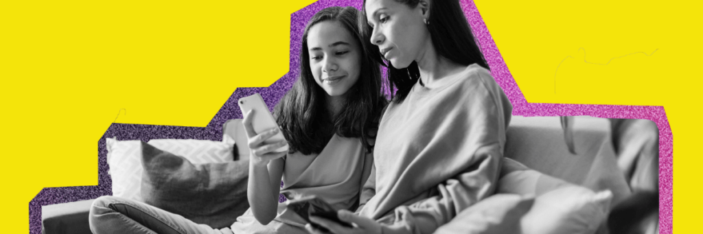 mom and daughter both looking at cellphone