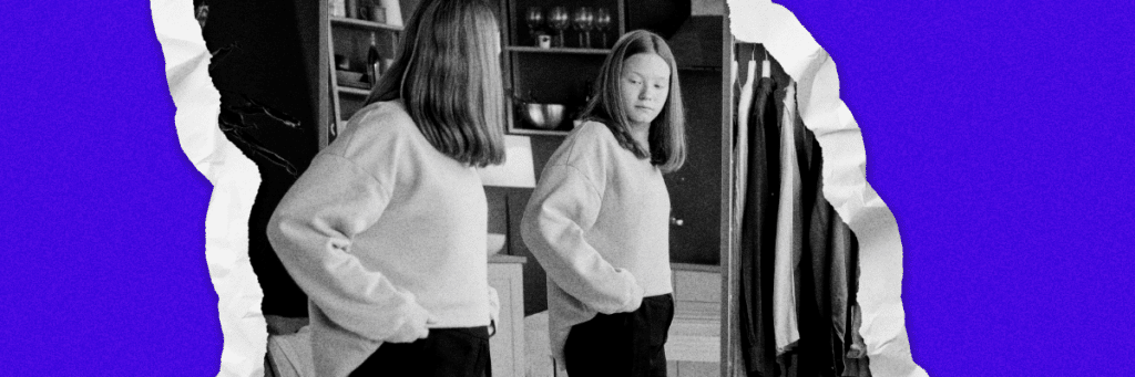 girl looking at herself in the mirror