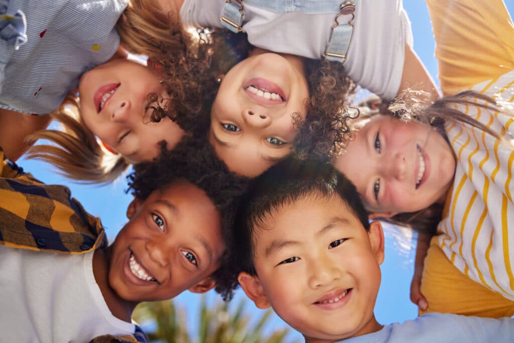 five kids smiling looking down at the camera