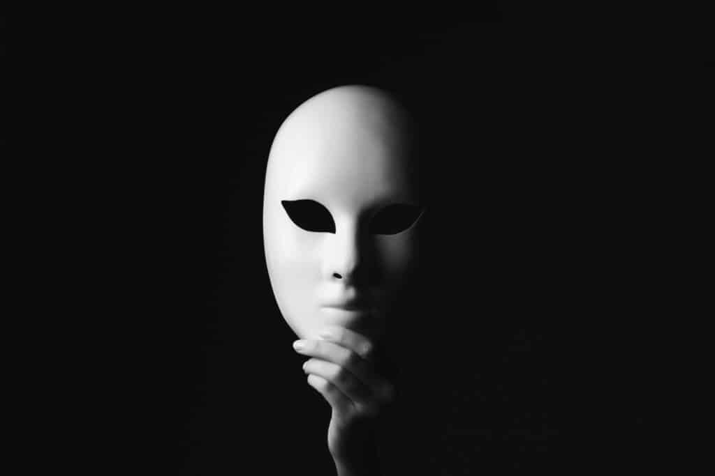 hand holding a mask