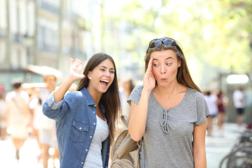teen girl swerving another teen girl saying hi