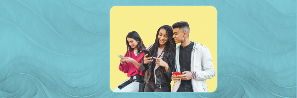 teens smiling looking at their phones