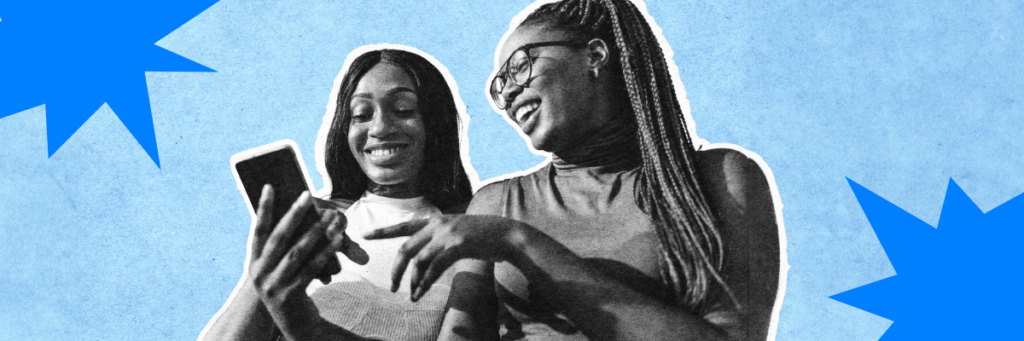 two teens smiling at a cell phone