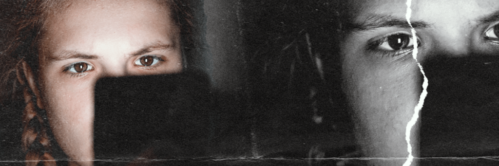 teen looking at phone screen and the light of the screen is lighting up their face but the phone occludes most of their face so you can only really see their focused eyes over the top